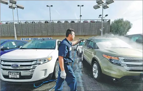  ?? PROVIDED TO CHINA DAILY ?? A worker cleans Ford SUVs at the Star Ford dealership in Los Angeles, California.