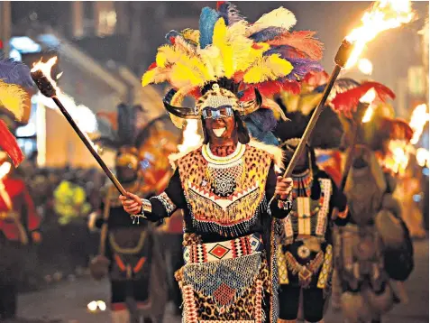  ??  ?? The ‘Zulu warriors’ of Lewes Borough Bonfire Society have come under fire for ‘blacking up’ for the town’s annual bonfire night