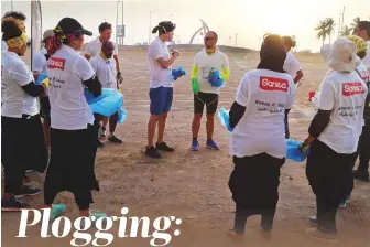  ?? Courtesy: Hejaz Ploggers, Jeddah ?? Above: Members of Hejaz Ploggers in Jeddah discuss their plan of action before each member sets out on individual litter runs. Left: A Hejaz Ploggers member holds up the group’s T-shirt.