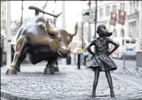  ?? ASSOCIATED PRESS ?? The “Fearless Girl” statue in Manhattan was installed this month to highlight the dearth of women on corporate boards.