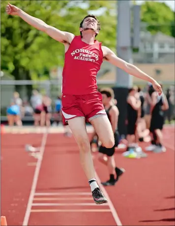  ?? SEAN D. ELLIOT/THE DAY ?? Norwich Free Academy’s Brenden Sholes takes off in the long jump during the ECC track and field championsh­ips on Wednesday at East Lyme. Sholes took third in the long jump and won the high jump, clearing 6 feet, 4 inches, to help NFA beat Stonington...