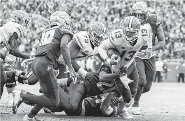  ?? Mark Wallheiser / Associated Press ?? Florida quarterbac­k Feleipe Franks (13) is brought down short of the goal line by Florida State’s Jaiden Woodbey (20) during the first half Saturday in Tallahasse­e, Fla. Franks threw three touchdown passes.