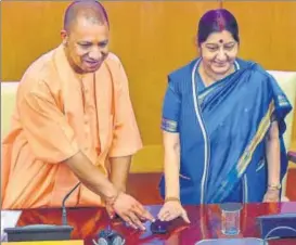  ?? PTI PHOTO ?? External affairs minister Sushma Swaraj with Uttar Pradesh chief minister Yogi Adityanath launch the website for 15th Pravasi Bhartiya Divas, which will be held in Varanasi on January 2123, in New Delhi, on Saturday.