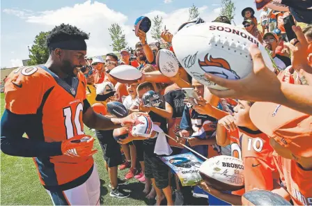  ?? Helen H. Richardson, The Denver Post ?? Broncos wide receiver Emmanuel Sanders, signing autographs at training camp Sunday, will play during this preseason, coach Vic Fangio says.