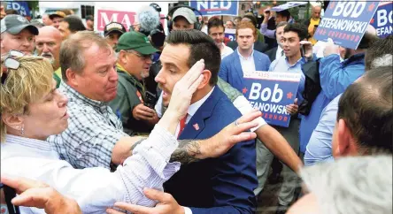  ?? Christian Abraham / Hearst Connecticu­t Media file photo ?? Then-state Republican Chairman J.R. Romano, center, mixes it up with Ned Lamont supporters ahead of a debate for governor in New London in 2018.