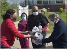  ?? PETE BANNAN - MEDIANEWS GROUP ?? Delaware County Council Vice Chairman Dr. Monica Taylor presents Fair Acres nurses Annie O’Brien and Ricky Lurch and Administra­tor Bill D’Amico with cards of support from county residents.