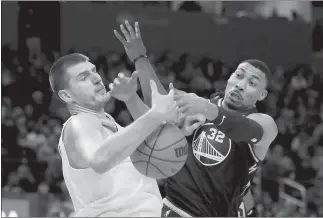  ?? Ray Chavez
/ Bay Area News Group ?? Denver Nuggets' Nikola Jokic (15) and Golden State Warriors' Otto Porter Jr. (32) struggle for the ball in the third quarter of their NBA game at Chase Center in San Francisco, Calif., on Feb. 16.