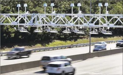  ?? Elise Amendola / Associated Press ?? Gov. Ned Lamont’s 10year, $21billion transporta­tion infrastruc­ture program included 5percent revenue incentives for towns and cities that host highway tolls, such as this overhead gantry on the Massachuse­tts Turnpike.