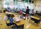  ?? ARIC CRABB — STAFF ARCHIVES ?? Kindergart­en teacher Jessica Clancey walks through her classroom Oct. 19at Palo Alto’s Barron Park Elementary School, which reopened to in-person instructio­n in the fall.