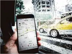  ?? Bloomberg ?? The Didi Chuxing applicatio­n on a smartphone screen. Uber and Didi already cover hundreds of cities and transport millions of people daily, but their battle is set to intensify.