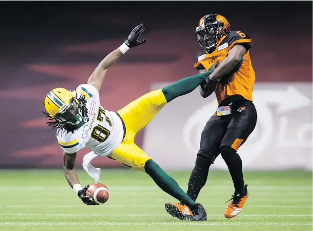  ?? — THE CANADIAN PRESS ?? Edmonton receiver Derel Walker is upended by B.C. defender T.J. Lee after making a grab on Thursday night. The Lions defence awoke with a vengeance, shutting down the Eskimos’ high-octane attack in the second half en route to a 31-23 win at home.