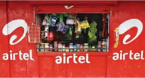  ??  ?? A vendor waits for customers at his grocery shop, painted with an advertisem­ent for Bharti Airtel, in the southern Indian city of Kochi. The company says it is considerin­g an IPO of its telecoms tower unit. — Reuters