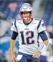  ?? Rey Del Rio Getty Images ?? TOM BRADY has a soft spot for the helmet he wore en route to four Super Bowl wins for New England.