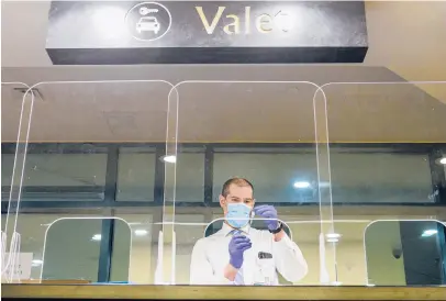  ?? MARKMIRKO/HARTFORDCO­URANT ?? AHartford HealthCare official prepares COVID-19 vaccines in the valet booth at Foxwoods Casino Monday. Hartford Healthcare and Foxwoods have opened a mass vaccinatio­n clinic at the casino, where officials expect to vaccinate more than 800 people per day.