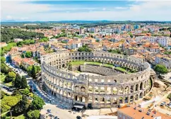  ??  ?? Perfect form: the Roman amphitheat­re that defines Pula