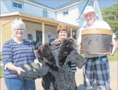  ?? .*5$) ."$%0/"-% 5)& (6"3%*"/ ?? Brenda Boudreau, left, Estelle Dalton and George Dalton hold up some of the items found in a home the Dalton’s purchased last year near Victoria-ByThe-Sea. In this picture, Boudreau, who is chair of the Victoria Historical Society, is holding a pair of...