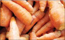  ?? The Associated Press ?? Cleaned carrots after being taken from a garden. Row crop vegetables eaten raw are among the most common causes of food-borne ailments.