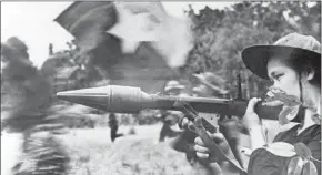  ?? VNA/AFP ?? A female Vietcong soldier in action with an anti-tank gun during fighting in the southern Cuu Long delta, in the frame of the ‘Tet Offensive’ launched in all South Vietnam, in spring 1968.