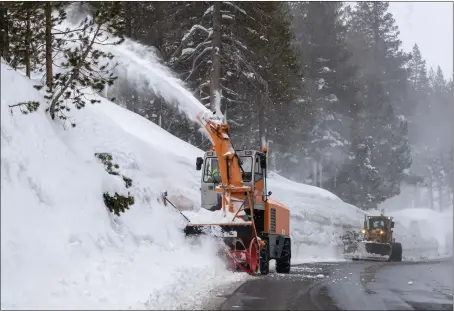  ?? PHOTOS BY KARL MONDON — STAFF PHOTOGRAPH­ER ?? Snow is cleared from the roadway in Soda Springs as an atmospheri­c river storm approaches the Sierra on Thursday.