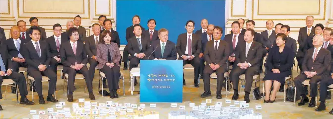  ?? Yonhap ?? President Moon Jae-in speaks at the start of his meeting with 128 executives from the country’s top business groups at Cheong Wa Dae, Tuesday. Participan­ts included Samsung Vice Chairman Lee Jae-yong, SK Chairman Chey Tae-won, LG Chairman Koo Kwang-mo and Hyundai Motor Executive Vice Chairman Chung Eui-sun.