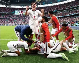  ??  ?? We Kaned them...captain Harry is mobbed after 2nd goal seals victory