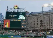  ?? Julio Cortez/Associated Press ?? A crowd observes a moment of silence as the Baltimore Orioles honor Hall of Fame third baseman Brooks Robinson after his passing prior to a game against the Washington Nationals on Tuesday in Baltimore.