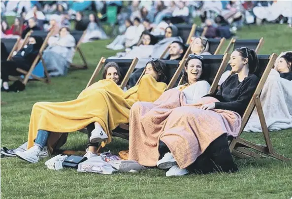  ??  ?? Enjoying the outdoor cinema experience