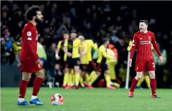  ?? AP ?? Liverpool fullback Andy Robertson, right, vents his frustratio­n as Watford players celebrate during their 3-0 win over the Premier League leaders.