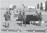  ??  ?? Algerian soldiers stand at the entrance of the gas plant in In Amenas Thursday as the government shows the site of the terrorist attack to journalist­s for the first time since 37 hostages and 29 militants were killed in a four-day siege.