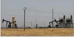  ?? AP PHOTO BY HUSSEIN MALLA ?? This July 30 photo shows an oil field controlled by the Kurdishled Syrian Democratic Forces (SDF), in Rmeilan, Hassakeh province, northeast Syria.