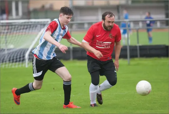  ??  ?? Chris O’Sullivan, Tralee Bay FC, (in red) and Colm McCarthy, Abbeydorne­y FC, going for the ball in the Denny League Division 2 at Mounthawk, Tralee on Sunday