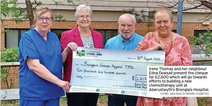  ?? HYWEL DDA HEALTH BOARD CHARITIES ?? Irene Thomas and her neighbour Edna Dowsall present the cheque for £2,600 which will go towards efforts to building a new chemothera­py unit at Aberystwyt­h’s Bronglais Hospital.