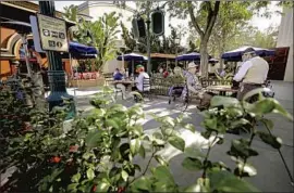  ?? Myung J. Chun Los Angeles Times ?? VISITORS can make table reservatio­ns for outdoor dining at Lamplight Lounge and Carthay Circle Lounge starting March 11. Above, park diners in November.