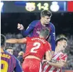  ?? AP ?? Barcelona’s Gerard Pique, top, scores against Girona.