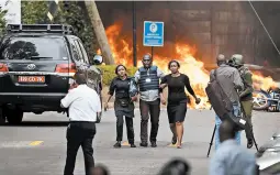  ?? BEN CURTIS/AP ?? Security forces help civilians flee a hotel complex Tuesday in Nairobi, Kenya. A police officer said at least 15 people died. Al-Shabab claimed responsibi­lity for the attack.