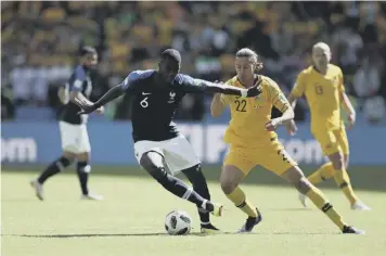  ??  ?? 0 Socceroo Irvine tussles with France’s Paul Pogba at the 2018 World Cup finals in Russia