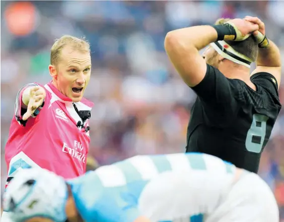  ?? Picture / Getty Images ?? Referee Wayne Barnes gets his message across to All Blacks captain Kieran Read, among others.