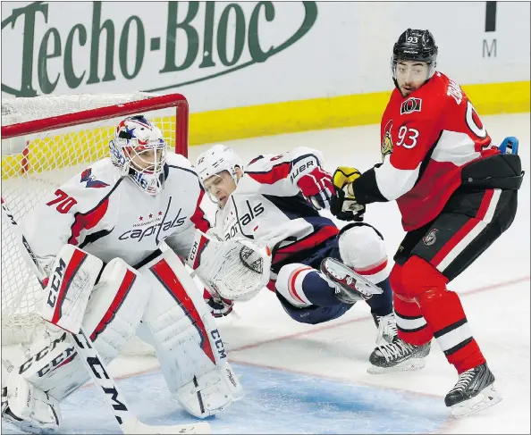  ?? — THE CANADIAN PRESS FILES ?? Ottawa Senators’ Mika Zibanejad checks Washington Capitals’ Eveny Kuznetsov in Ottawa on Tuesday. Ottawa is a team that never completely bottoms out in the standings. Zibanejad is the team’s last top-10 draft pick, taken sixth overall in 2011.