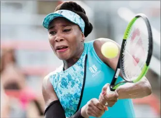  ?? The Canadian Press ?? Venus Williams of the United States returns to Caroline Dolehide of the United States during their first round match at the Rogers Cup tennis tournament in Montreal, Monday.