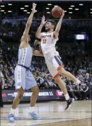  ?? AP PHOTO/JULIE JACOBSON ?? Virginia guard Ty Jerome (11) shoots against North Carolina forward Garrison Brooks (15) during the second half of an NCAA college basketball game for the Atlantic Coast Conference men’s tournament title Saturday, March 10, 2018, in New York. Virginia...