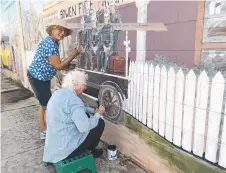  ?? Picture: SUPPLIED ?? FRESHEN-UP: Ann Bowden and Toy Cook work on the 1924 Fire Truck, Bowen mural.