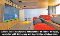  ??  ?? Another stellar feature is the media room at the front of the house, which has an 80-inch screen and tiered seating with bean bags.