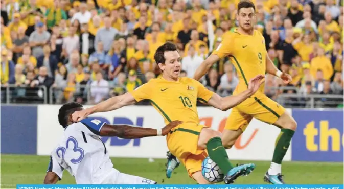  ??  ?? SYDNEY: Honduras’ Johnny Palacios (L) blocks Australia’s Robbie Kruse during their 2018 World Cup qualificat­ion play-off football match at Stadium Australia in Sydney yesterday. — AFP