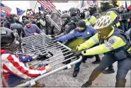  ?? (AP Photo/John Minchillo, File) ?? Supporters of then-President Donald Trump tussle with police over a barrier at the Capitol on Jan. 6 in Washington. Months after what is being called an insurrecti­on, Trump and his supporters are revising their account of that day.