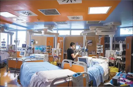  ?? Antonio Masiello Getty Images ?? A HEALTH WORKER sets up equipment at a hospital for COVID-19 patients before the facility’s opening in Casal Palocco in Rome.