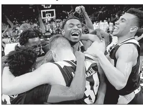  ?? AP/PAUL SANCYA ?? Northern Kentucky players celebrate Tuesday after defeating Wright State 77-66 for the Horizon League Tournament championsh­ip in Detroit.