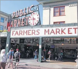  ??  ?? Morning shoppers arrive at Pike Place Market.