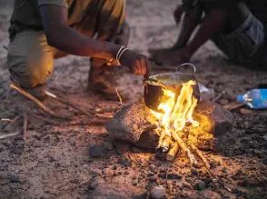  ?? ?? A group of interprete­rs prepare their food a few metres from the secure bivouac of the MINUSMA Long Range Reconnaiss­ance Group (LRRG).