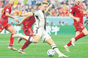  ?? — AFP photo ?? Niclas Fullkrug (centre) scores his team’s first goal during the Qatar World Cup Group E football match between Spain and Germany at the Al-Bayt Stadium in Al Khor, north of Doha.