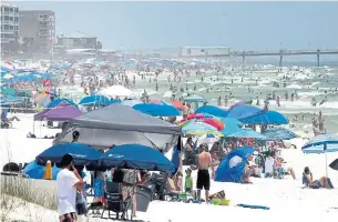  ?? MICHAEL SNYDER NORTHWEST FLORIDA DAILY NEWS ?? People pack beaches on Okaloosa Island, Fla., on Saturday as the Memorial Day weekend begins.